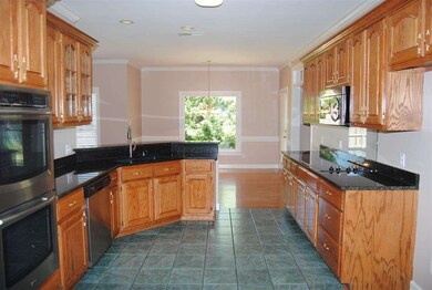 Spacious kitchen with granite counter tops, stainl