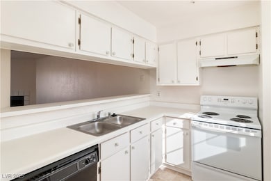 Kitchen featuring white range with electric stovet