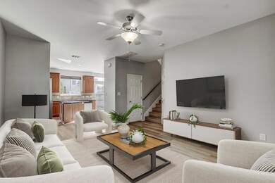 Living area featuring ceiling fan, light wood fin