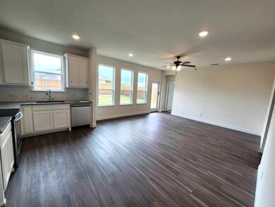 Kitchen featuring appliances with stainless steel finishes, ceiling fan, tasteful backsplash, white cabinetry, and dark hardwood / wood-style flooring