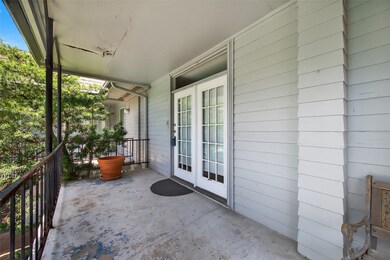 covered front porch with a light gray exterior and