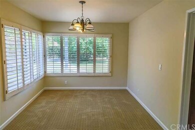 Dining room with plantation shutters and views of 