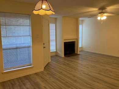 Unfurnished living room with ceiling fan, wood-typ