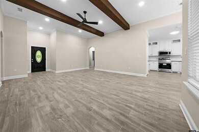 Unfurnished living room featuring light hardwood /