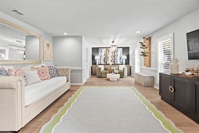 Living area featuring light wood-type flooring and recessed lighting