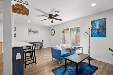 Living room with a ceiling fan, wood finished flo