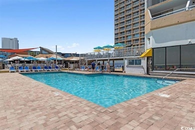 Community pool with a patio