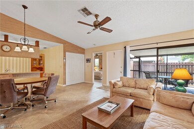 As you enter the front door through the lanai, you step into the spacious living/dining area. The kitchen is open to the room as well. The double door closet is where the washer and dryer are located.