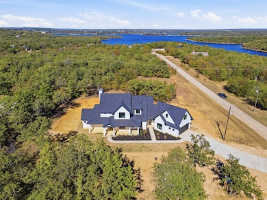 Aerial view of property and surrounding area featuring a large body of water