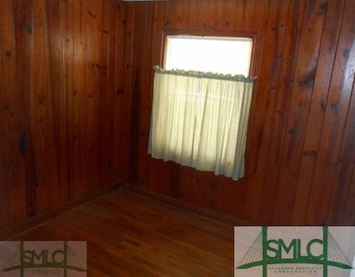 Bedroom. Bedroom with wood paneling and wood floor