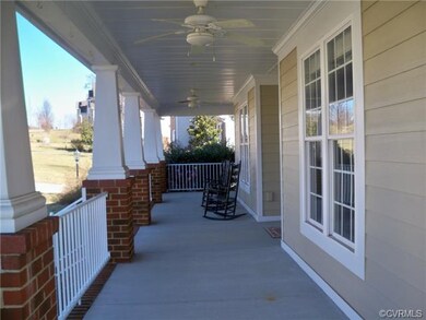 Beautiful wrap around front porch with fans