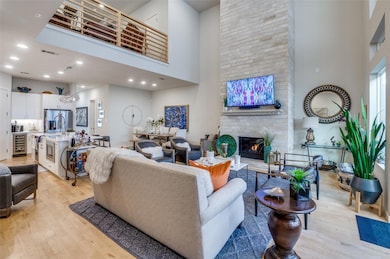 Living area featuring a fireplace, light wood-styl
