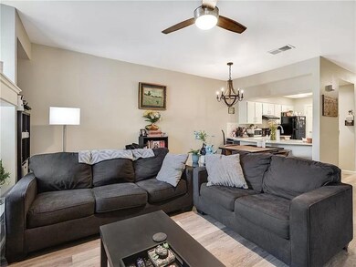 Living room featuring a chandelier, light wood-ty