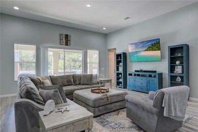 Living room featuring wood finished floors and recessed lighting