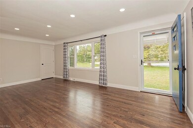 LARGE FAMILY ROOM WITH REFINISHED HARDWOOD FLOORS AND LARGE PICTURE WINDOW
