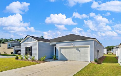 View of front facade with a garage and a front law