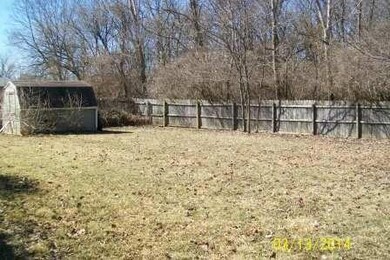 Fenced yard with storage shed