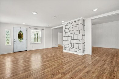 Entryway featuring wood finished floors, recessed lighting, and baseboards