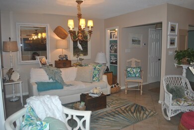 Living room featuring a chandelier and tile patter