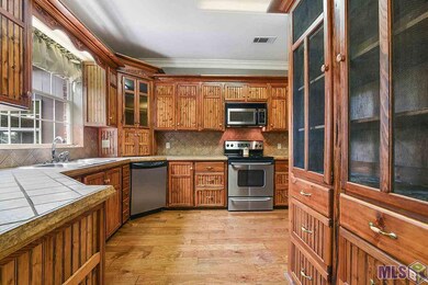 Stainless steel appliances.  Custom cypress cabine
