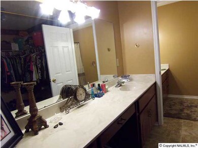 Dressing Room has a make-up vanity and sink combined with large walk-in closet