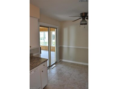 Sliders off Kitchen to enclosed porch with wood fi