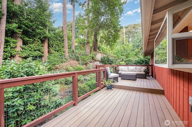 Large deck off kitchen for entertaining or enjoying the private and lush backyard.