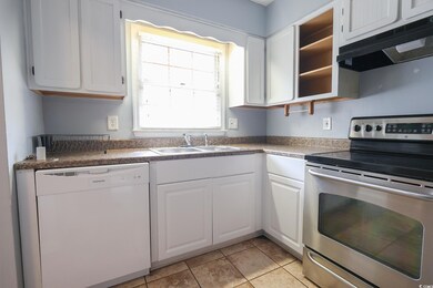 Kitchen with stainless steel electric stove, a sin