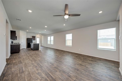 Unfurnished living room with dark wood-type floor