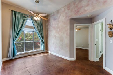 Unfurnished room featuring a ceiling fan and tile patterned flooring