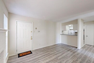 Foyer with light wood finished floors, a textured 