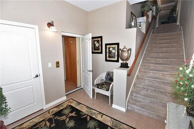 Foyer - garage entrance, elevator and stairwell up