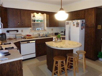 Spacious kitchen with appliances and island.