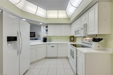 Kitchen with white appliances, light countertops, 