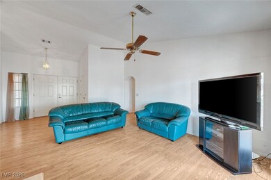 Living room with wood finished floors, arched walk