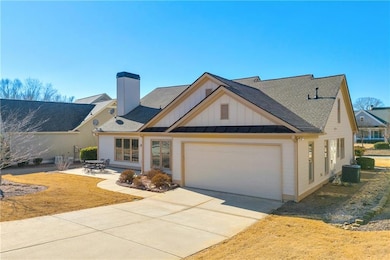 View of front of home featuring a garage and centr