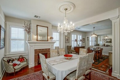 Living room with wood floors, picture molding, plantation shutters and plenty of natural light.  Currently being used as dining room.