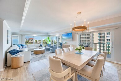 Dining space featuring crown molding and light woo