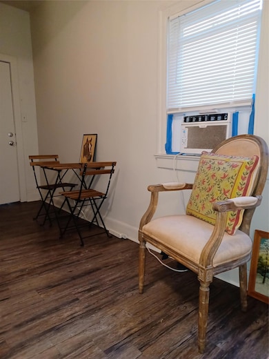 Sitting room featuring wood finished floors, cool