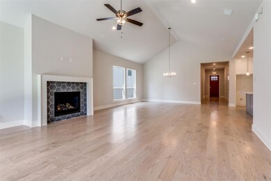 Unfurnished living room featuring ceiling fan with