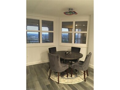 Breakfast nook next to kitchen overlooking front veranda and championship golf course. Plantation shutters throughout the full front of the condo.