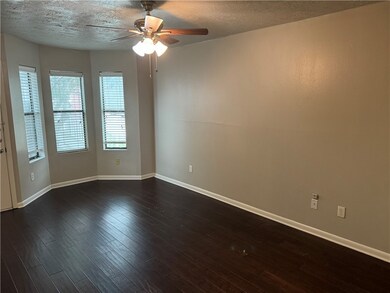 Spare room featuring ceiling fan, a textured ceili