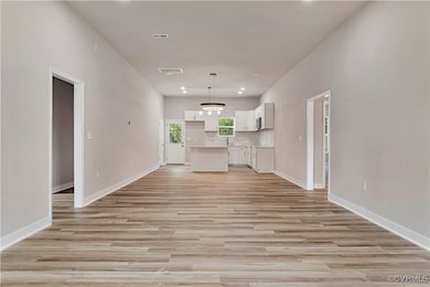  Living room featuring light wood-style flooring and recessed lighting