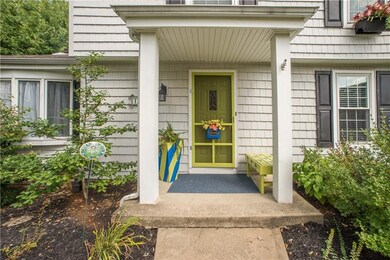 A covered front stoop, bright colors, and mature l
