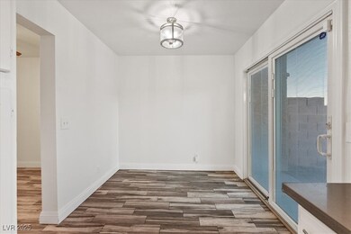 Unfurnished dining area with wood finished floors and baseboards