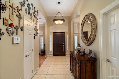 Entrance foyer with ornamental molding and baseboards
