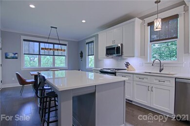 Kitchen island/bar adjacent to dining area which o