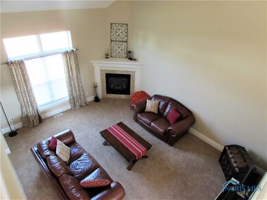 Family Room Offers White Trim, Large Windows, and Gas Fireplace