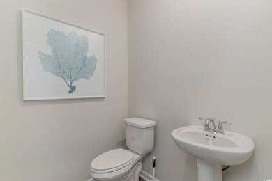 Bathroom with toilet, baseboards, and a sink