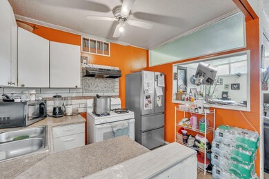 Kitchen featuring sink, tasteful backsplash, white